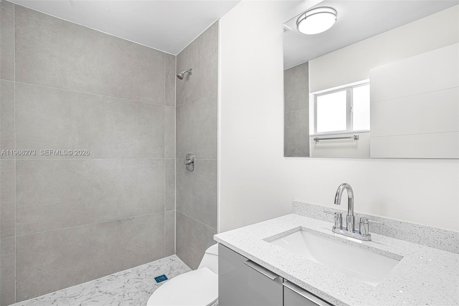 933 Northwest 50th Street Miami, FL 33127 - Photo 14 of 31 a bathroom with a sink toilet and vanity