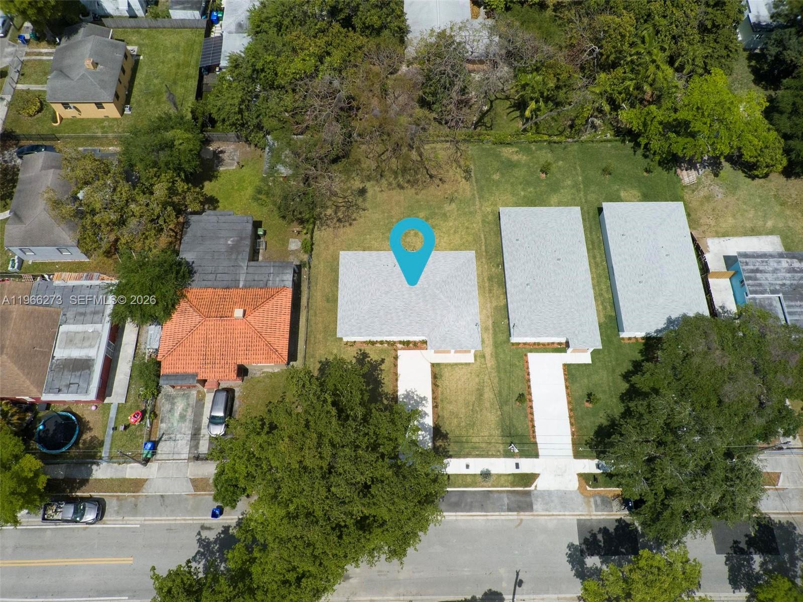 933 Northwest 50th Street Miami, FL 33127 - Photo 26 of 31 an aerial view of a house with a yard and tree s