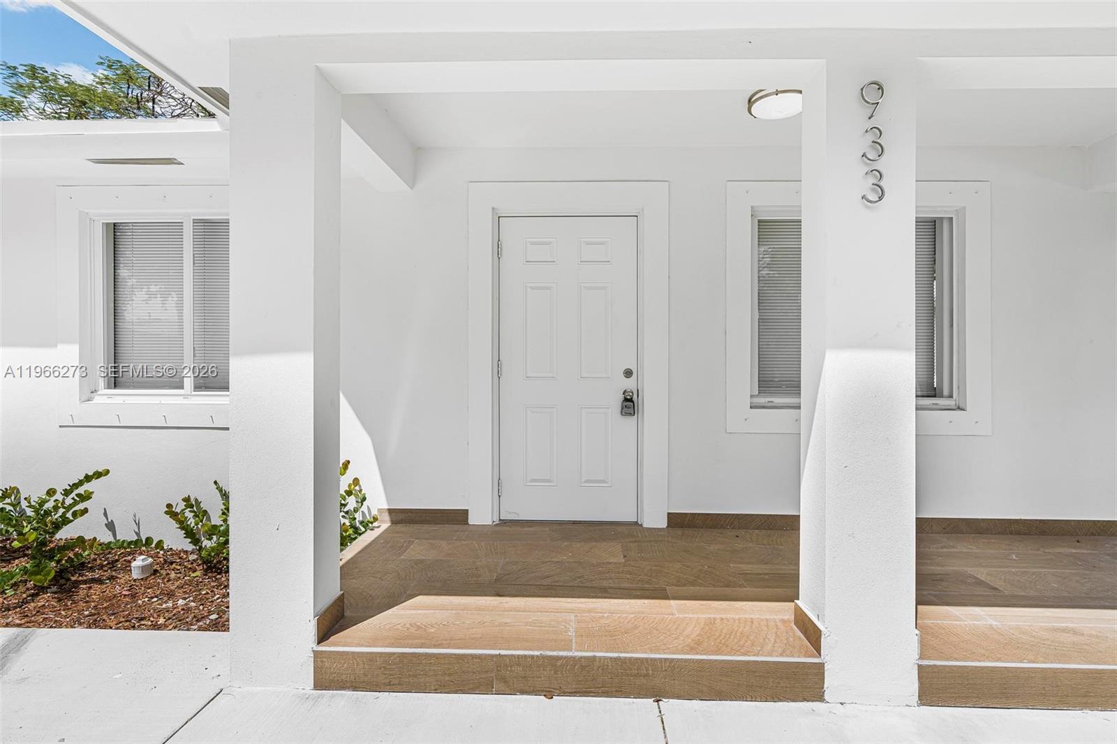 933 Northwest 50th Street Miami, FL 33127 - Photo 4 of 31 a view of door with wooden floor