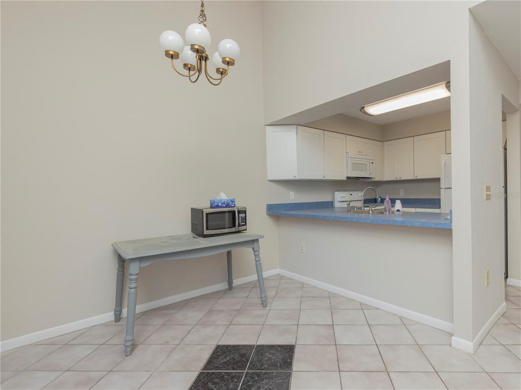 4356 Southwest 20th Lane Gainesville, FL 32607 - Photo 3 of 15 a kitchen with cabinets and window