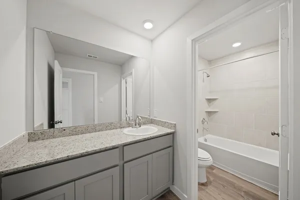 a white kitchen with a sink a stove a refrigerator and white cabinets