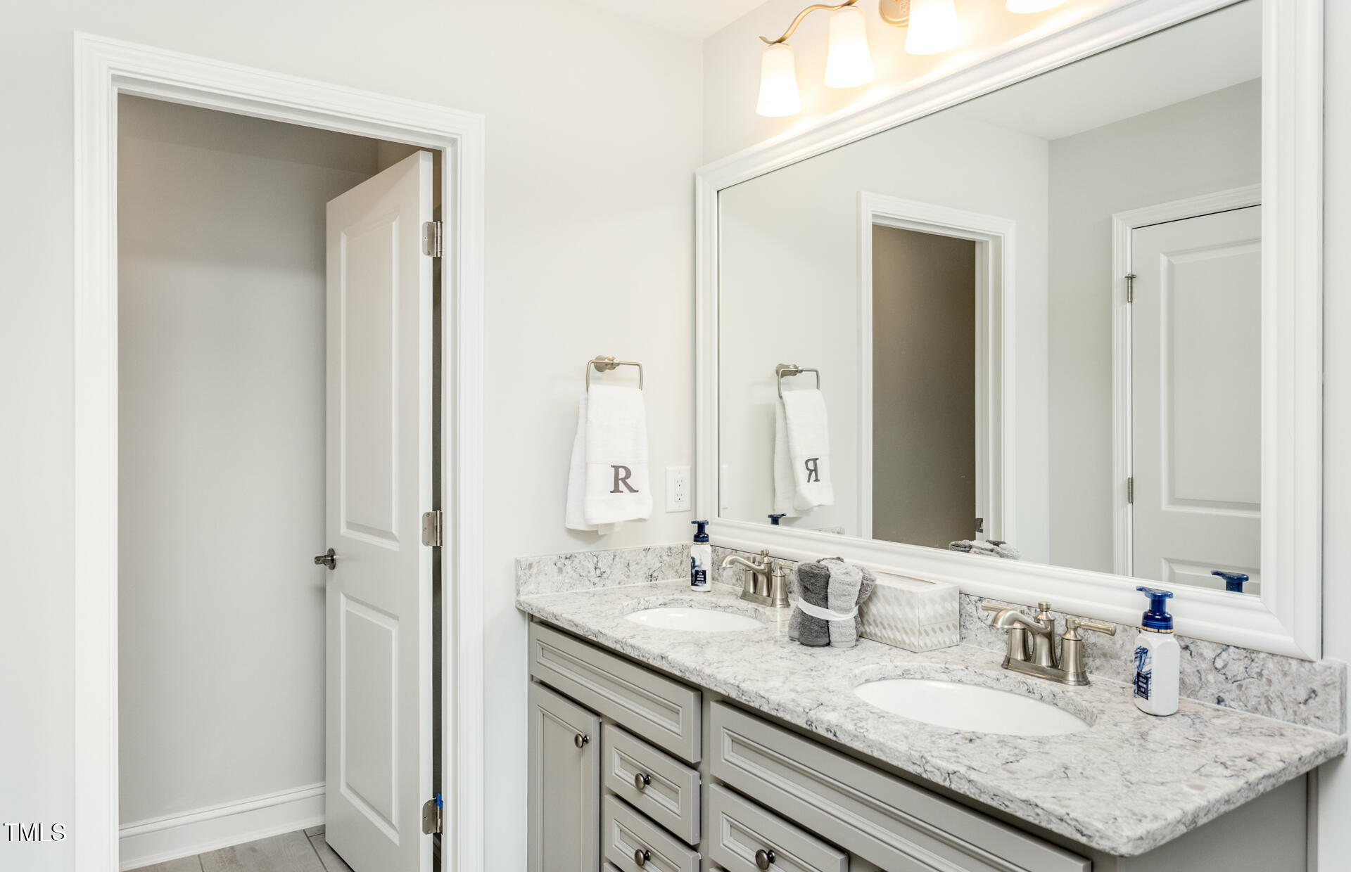 1111 Freestone Road Durham, NC 27703 - Photo 11 of 16 a bathroom with a granite countertop sink and a mirror