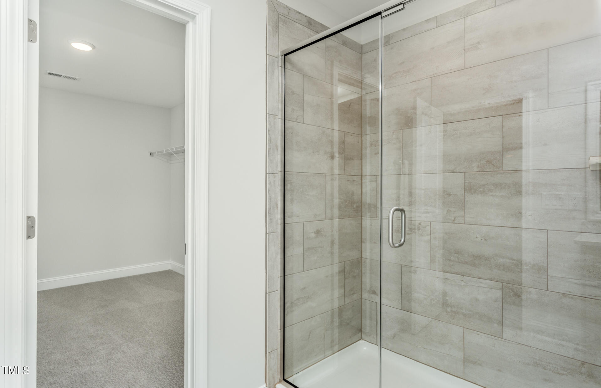 1111 Freestone Road Durham, NC 27703 - Photo 12 of 16 a bathroom with a glass shower door