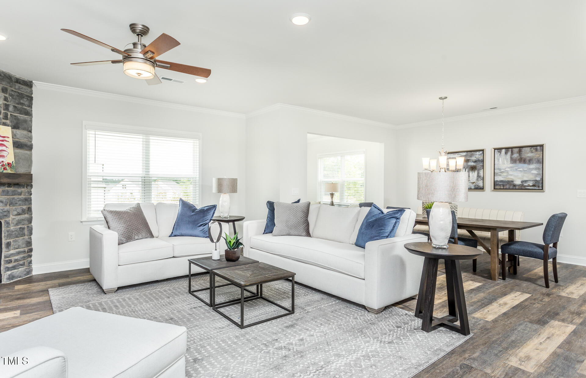 1111 Freestone Road Durham, NC 27703 - Photo 5 of 16 a living room with furniture a large window and a chandelier