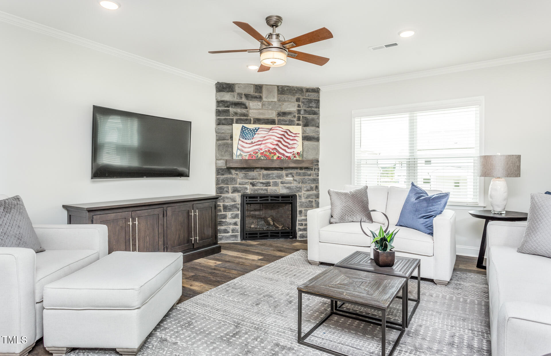 1111 Freestone Road Durham, NC 27703 - Photo 7 of 16 a living room with furniture a fireplace and a flat screen tv