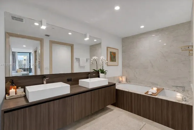 a bathroom with a double vanity sink and a mirror