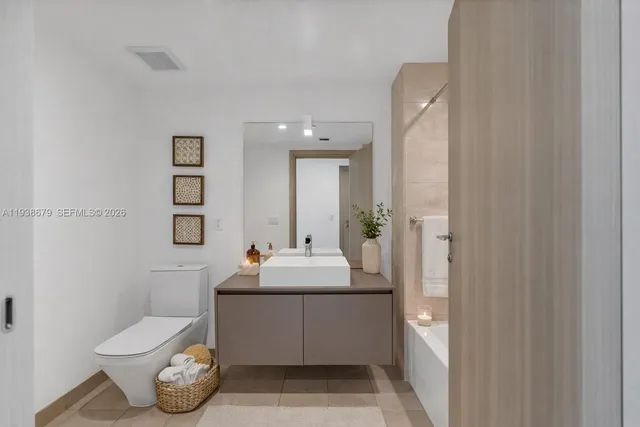 a bathroom with a sink toilet and mirror