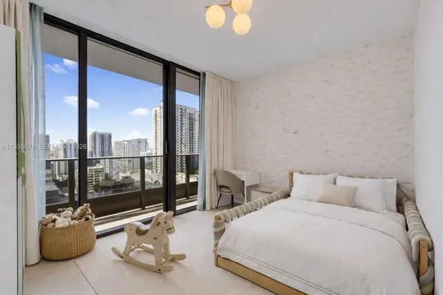 a bedroom with furniture and large windows