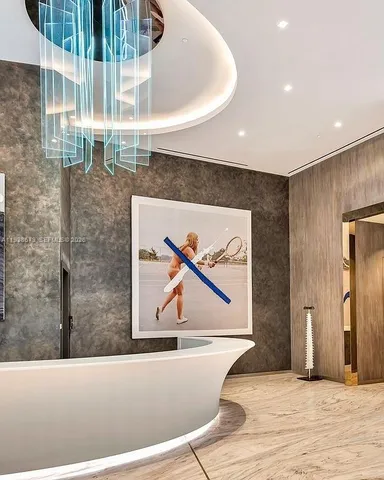 a dining room with furniture and a large window