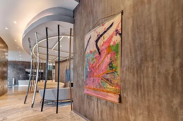 a living room with furniture and large windows