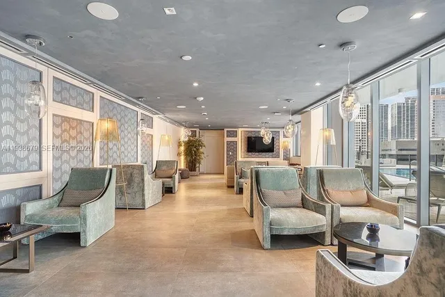 a view of a swimming pool with a patio and a yard