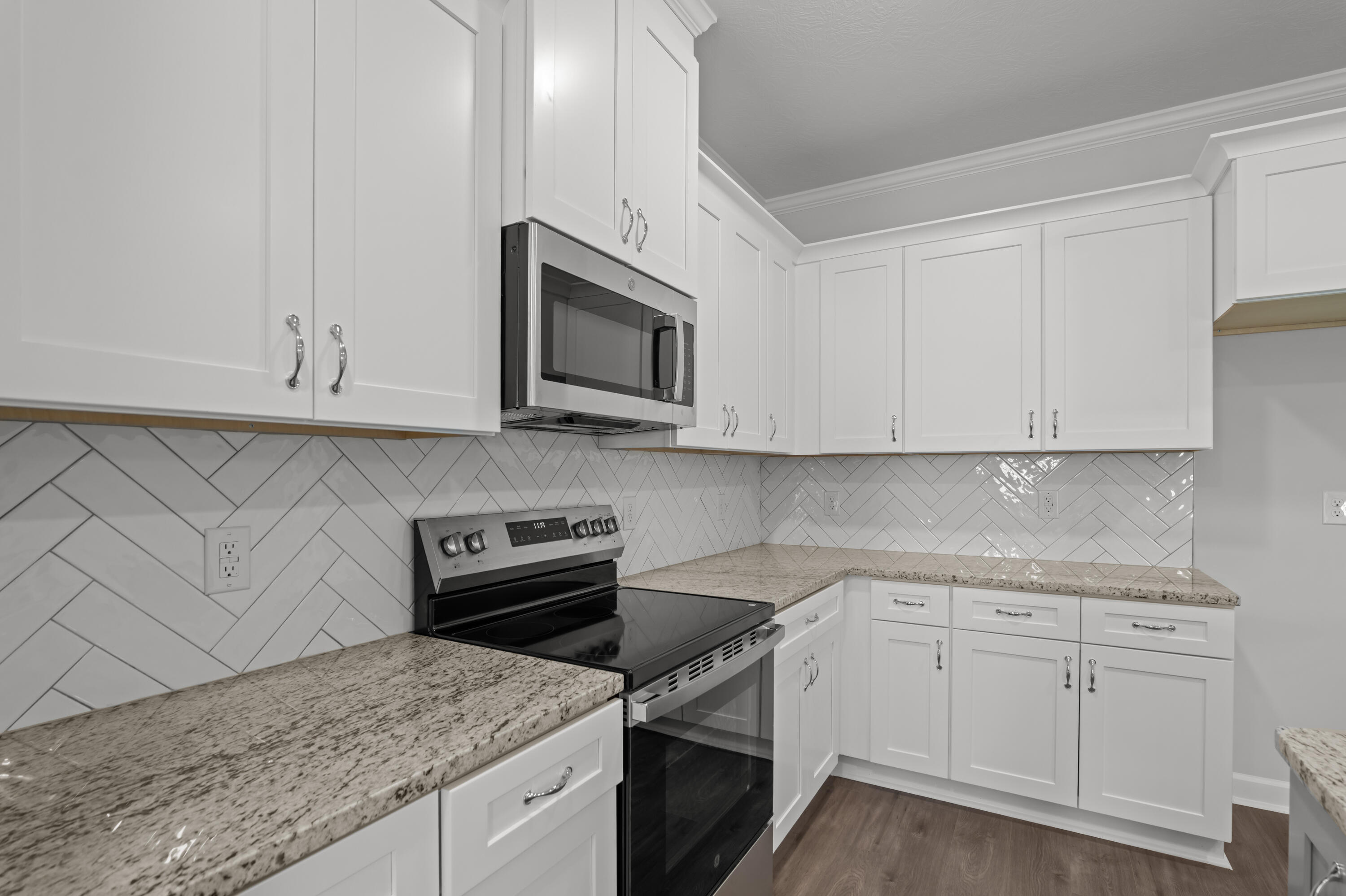 8163 Snelling Drive Aiken, SC 29803 - Photo 14 of 50 Stainless Steel appliances that include the microwave, electric stove and dishwasher.