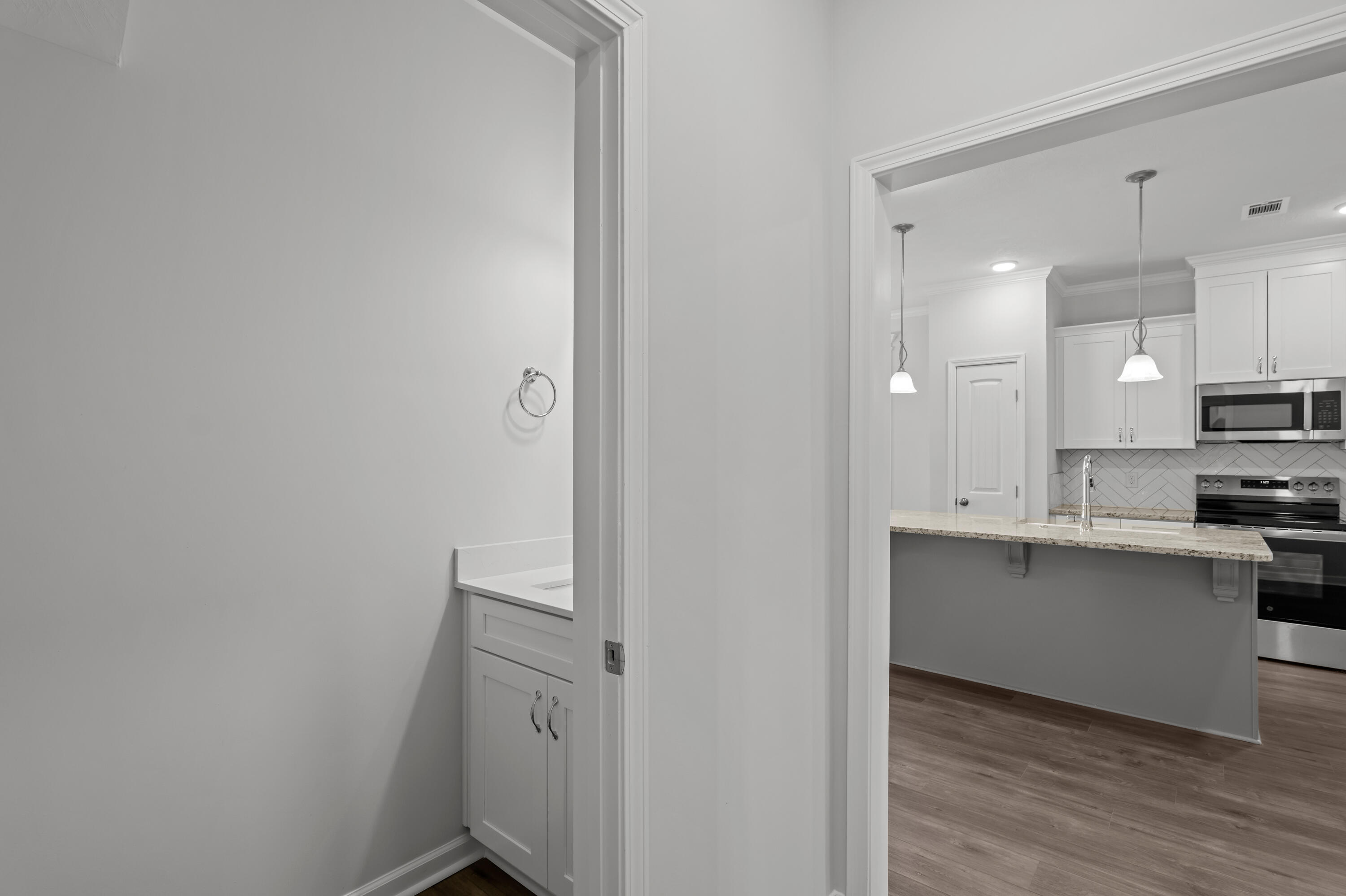 8163 Snelling Drive Aiken, SC 29803 - Photo 20 of 50 Hallway from garage, 1/2 bath and kitchen.