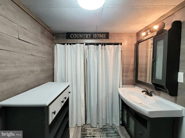a bathroom with a sink vanity and a mirror
