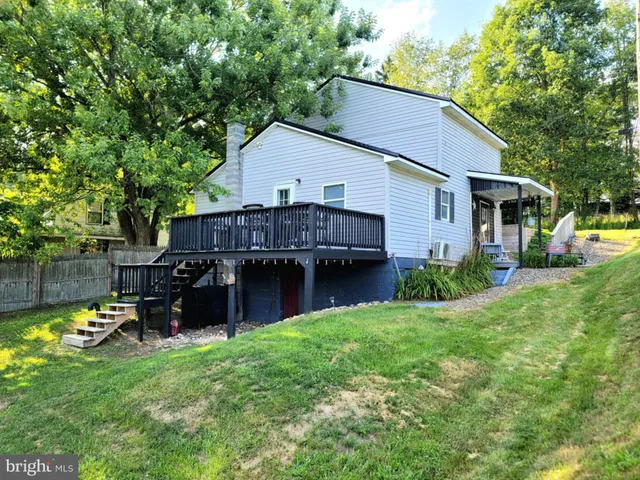 a view of a house with a yard and sitting area