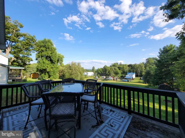 a view of a chairs and table on the wooden floor