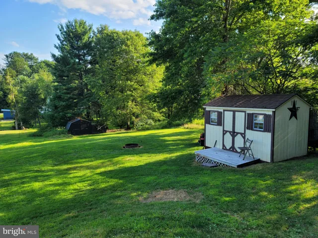 a view of a house with a yard porch and sitting area