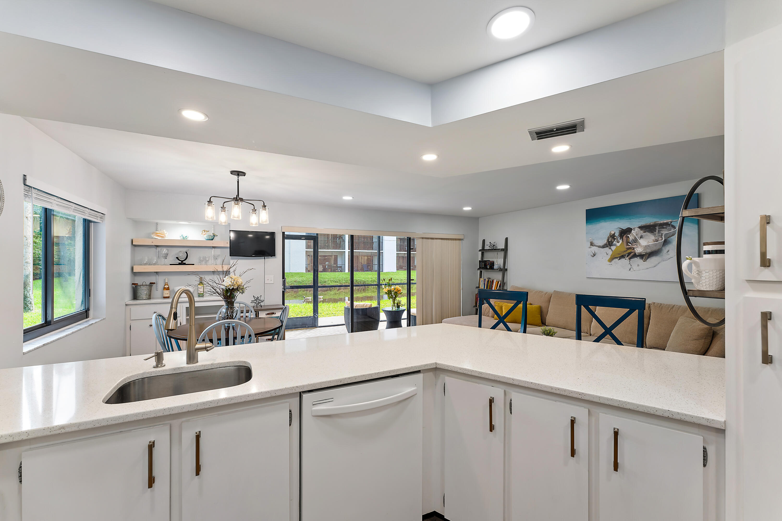 1605 Highway 1, Unit D101 Jupiter, FL 33477 - Photo 15 of 29 a kitchen with counter top space with sink and lots of white furniture