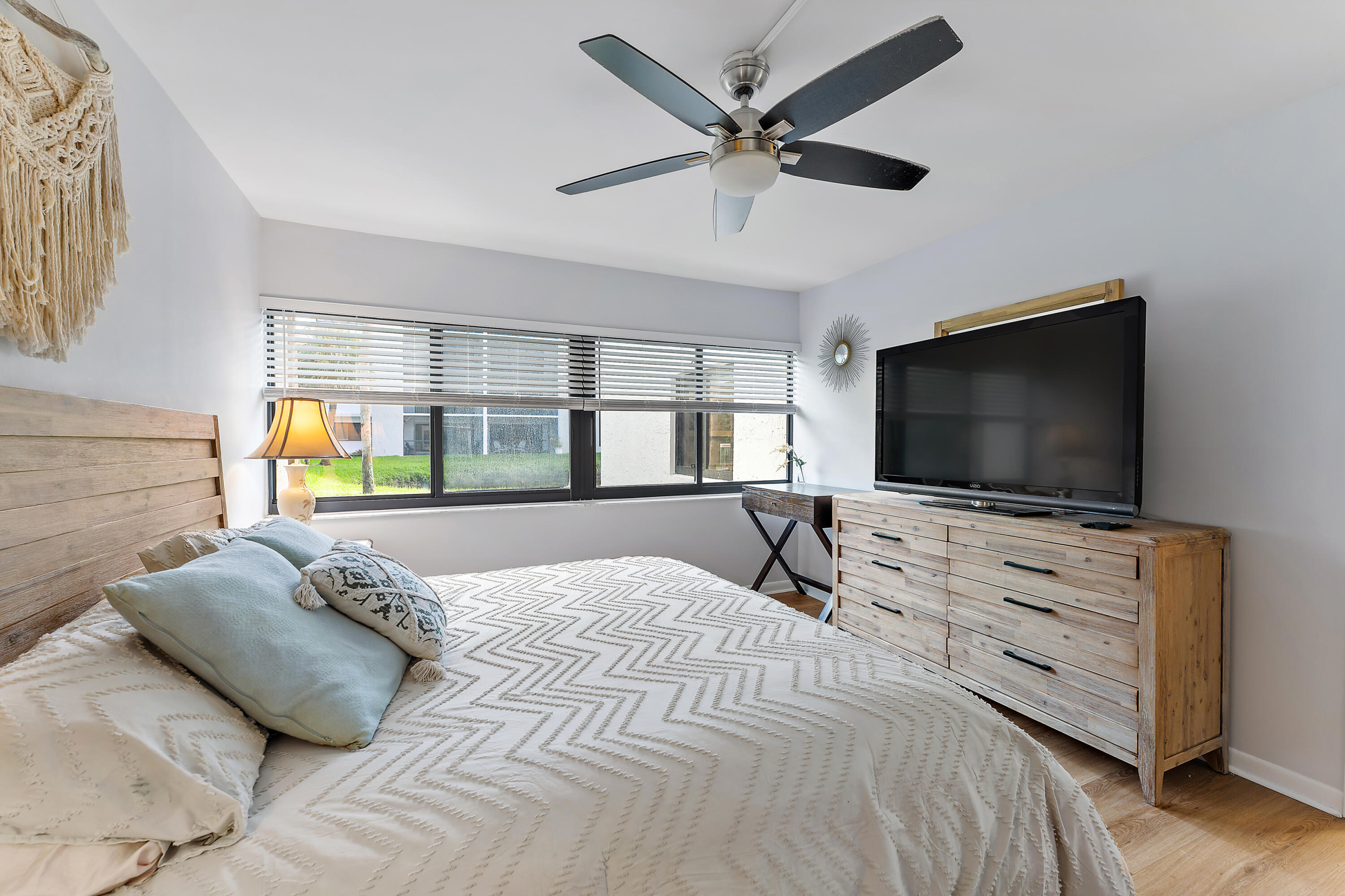 1605 Highway 1, Unit D101 Jupiter, FL 33477 - Photo 21 of 29 a bedroom with a bed and a flat screen tv