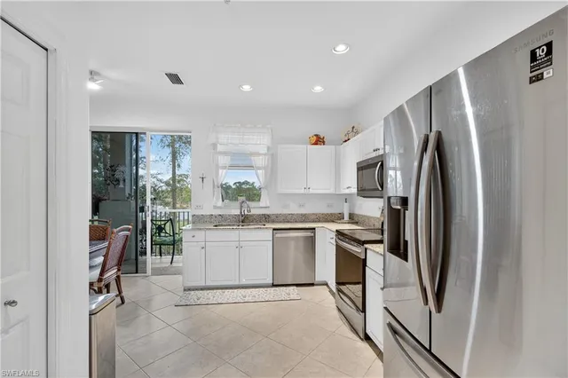a kitchen with refrigerator and cabinets