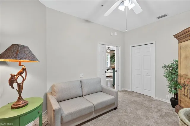 a living room with furniture a potted plant and a chandelier