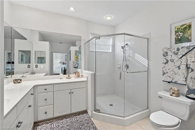 a spacious bathroom with a shower sink mirror and toilet