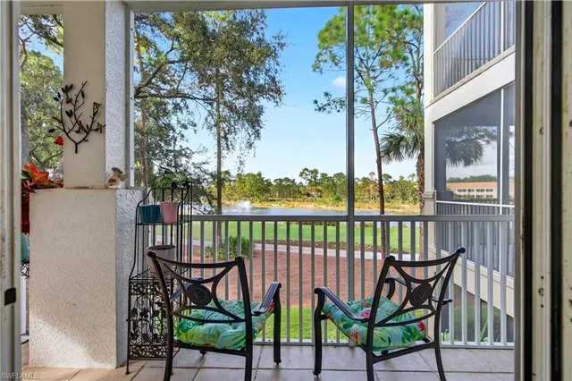 a view of a two chairs and table in the balcony