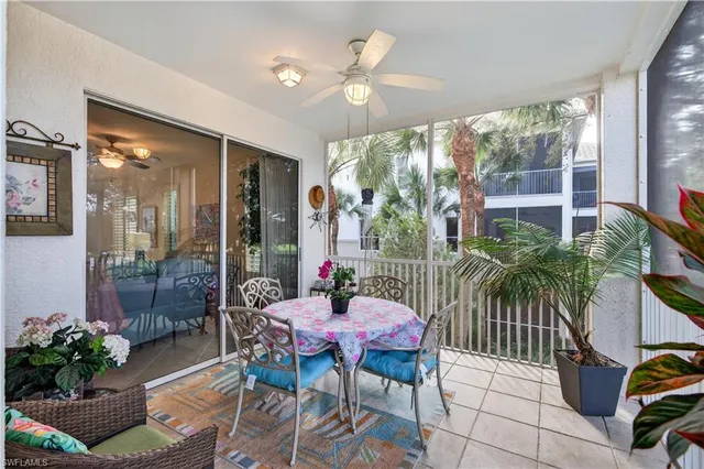 a dining room with furniture and a floor to ceiling window