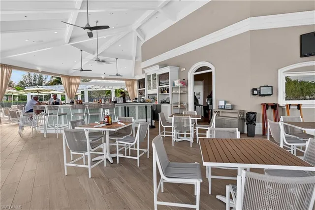 a view of a dining room with furniture wooden floor and chandelier