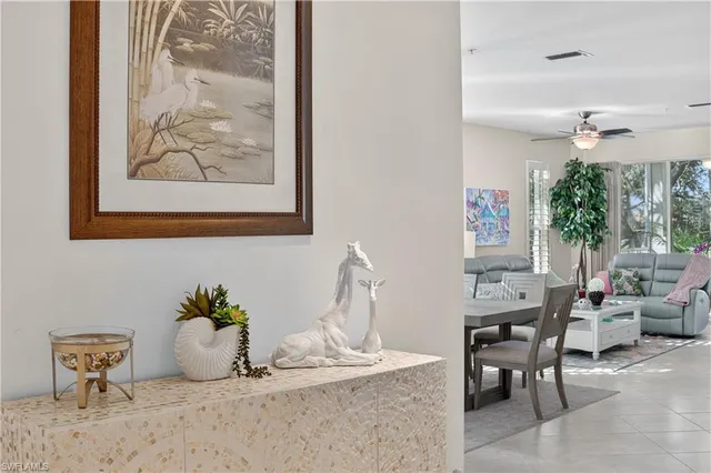 a dining room with furniture and a potted plant