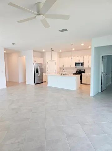 a view of a kitchen with a stove and a refrigerator