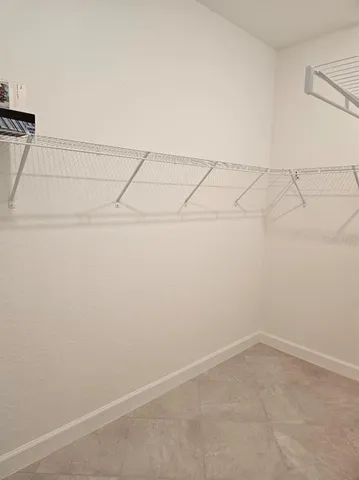 a bathroom with a double vanity sink a toilet and a shower