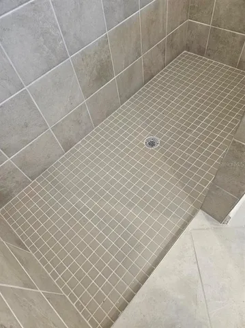 a white toilet sitting next to a shower