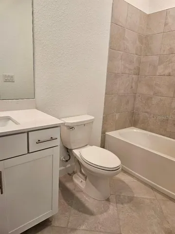 a bathroom with a sink a toilet and bathtub
