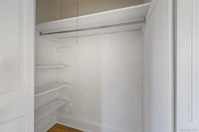 a view of a room with shelf on the wall