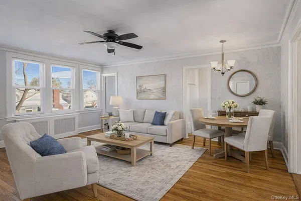 a living room with furniture a rug and a large window