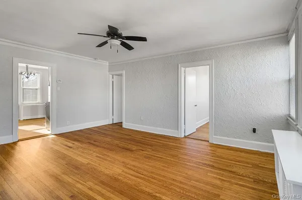 a view of an empty room and wooden floor
