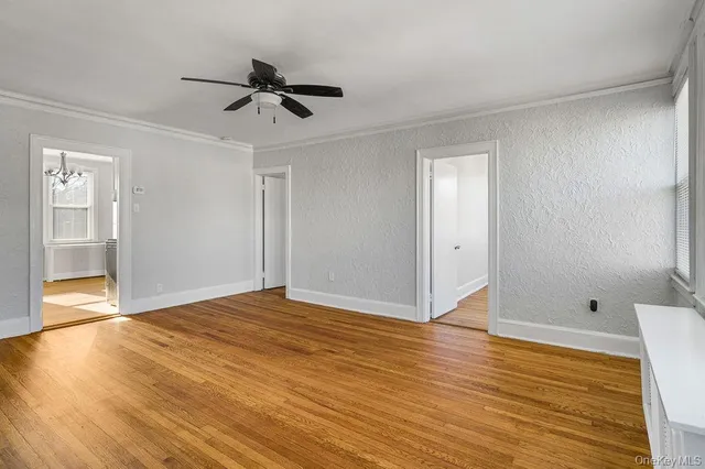 a view of an empty room and wooden floor