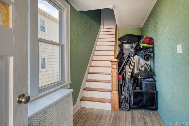 a view of a hallway with wooden floor and windows