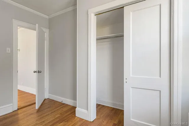a view of empty room with wooden floor