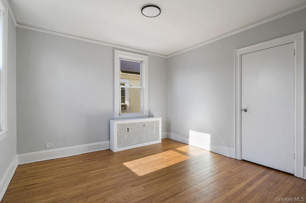 135 Webster Avenue, Unit 2 Harrison, NY 10528 - Photo 22 of 25 a view of empty room with wooden floor and fan