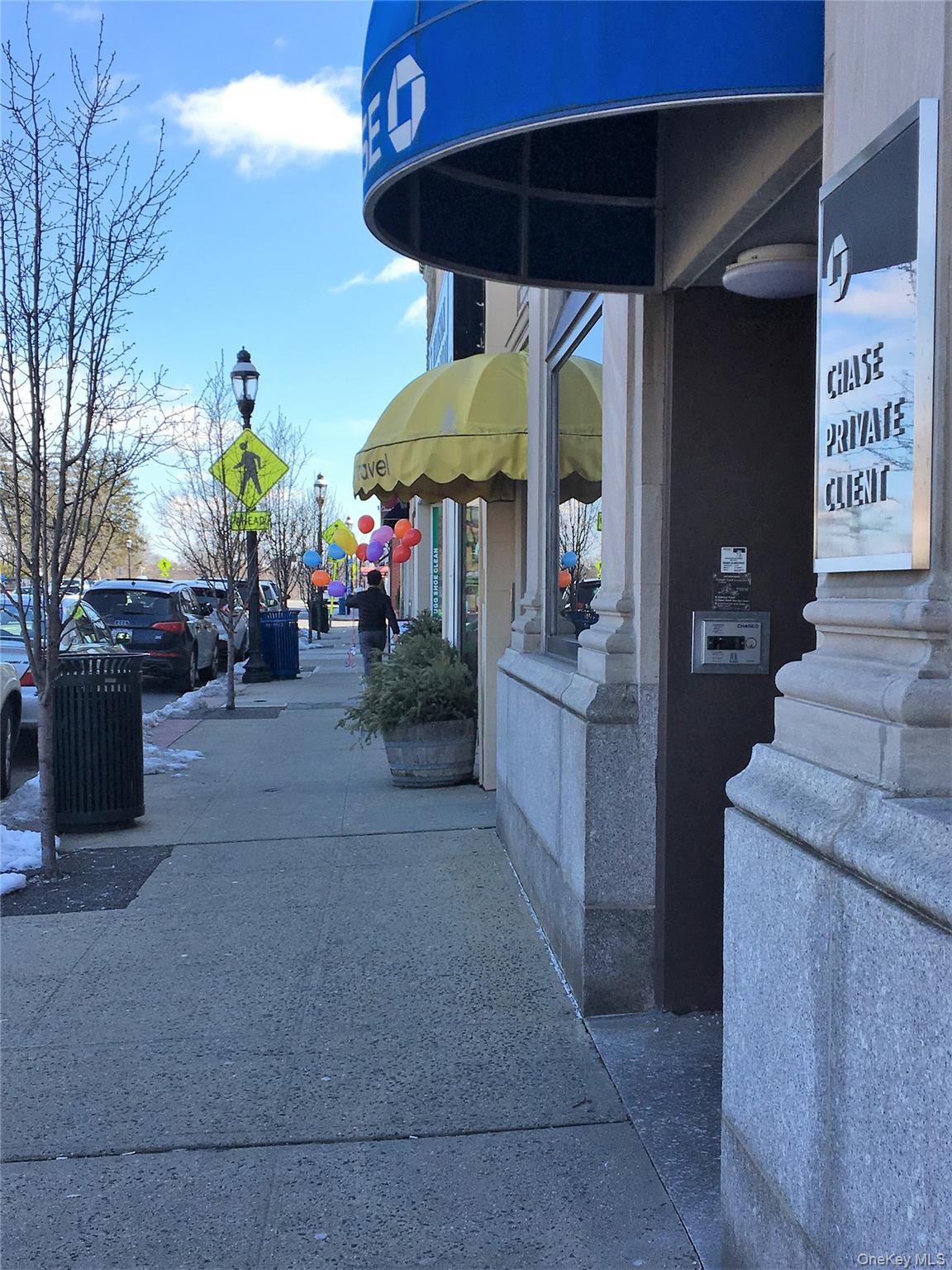 135 Webster Avenue, Unit 2 Harrison, NY 10528 - Photo 25 of 25 a view of the patio with table and chairs under an umbrella