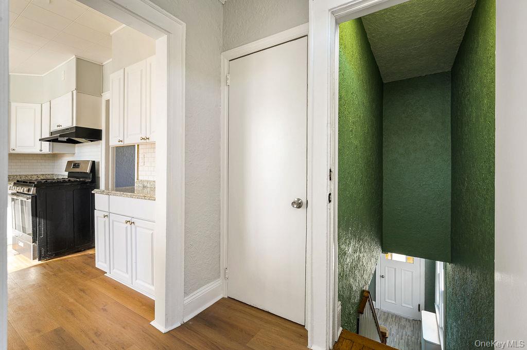 135 Webster Avenue, Unit 2 Harrison, NY 10528 - Photo 3 of 25 a kitchen with white cabinets and black appliances