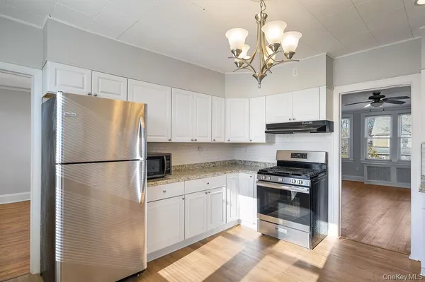 a kitchen with stainless steel appliances a refrigerator sink and cabinets