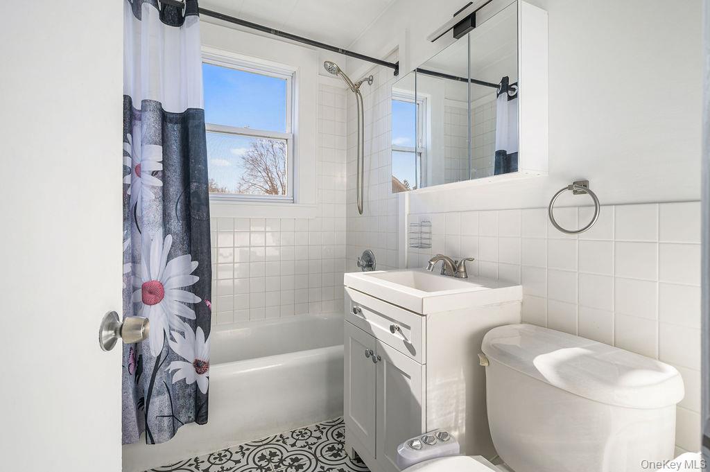 135 Webster Avenue, Unit 2 Harrison, NY 10528 - Photo 9 of 25 a bathroom with a sink toilet and shower