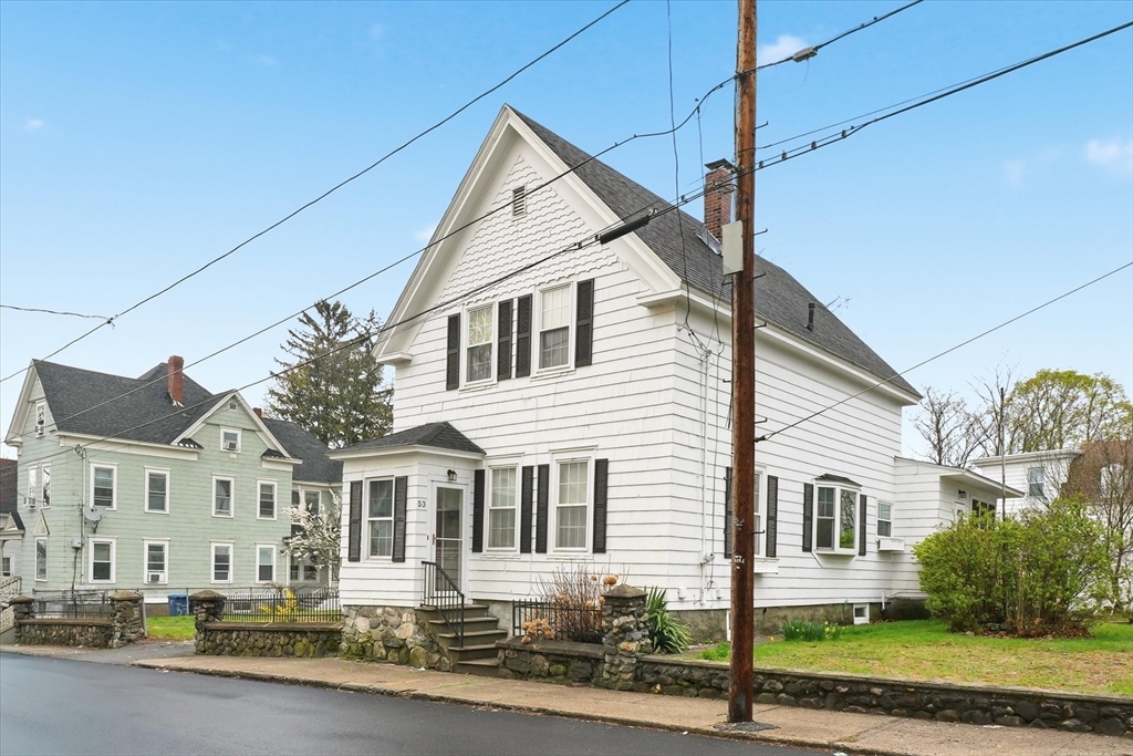 53 Kendall Street Lawrence, MA 01841 - Photo 1 of 36 a front view of a house with a yard