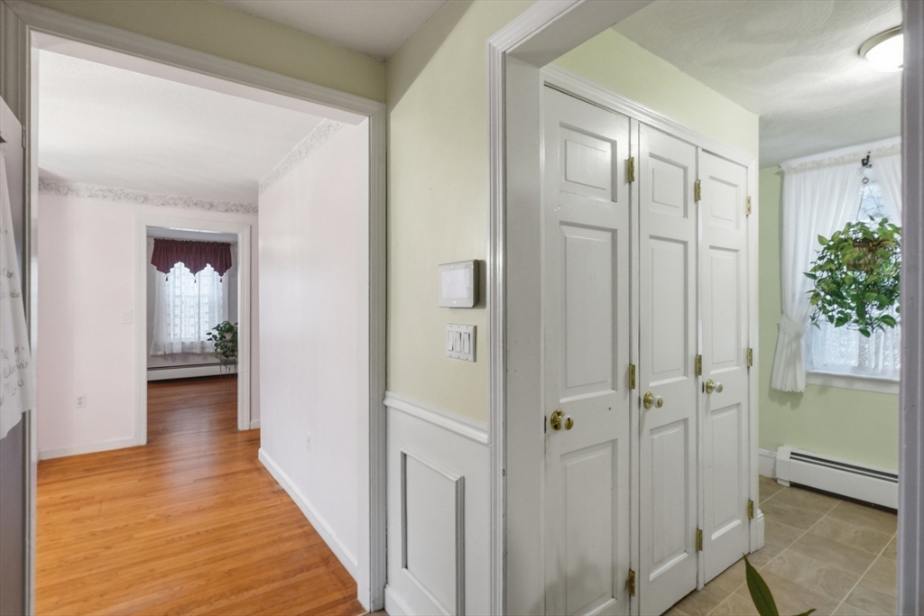 53 Kendall Street Lawrence, MA 01841 - Photo 11 of 36 a view of a hallway with wooden floor and a bathroom