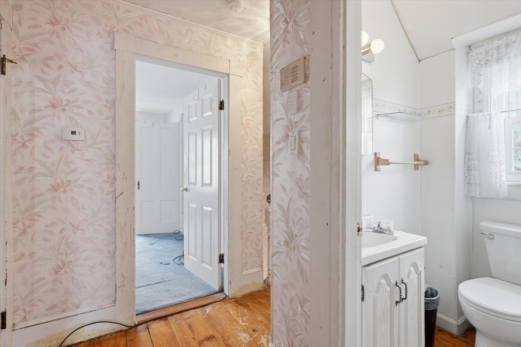 53 Kendall Street Lawrence, MA 01841 - Photo 19 of 36 a bathroom with a granite countertop shower mirror and a toilet