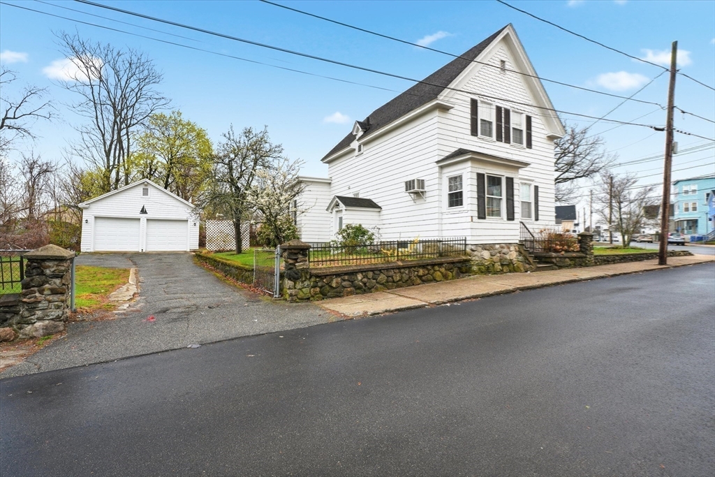 53 Kendall Street Lawrence, MA 01841 - Photo 2 of 36 a white house with a large tree in front of it