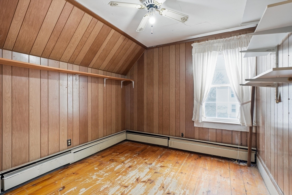 53 Kendall Street Lawrence, MA 01841 - Photo 24 of 36 a view of an empty room with wooden floor and a window